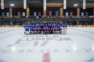 Philippine national team players in blue posing as a team on an ice rink